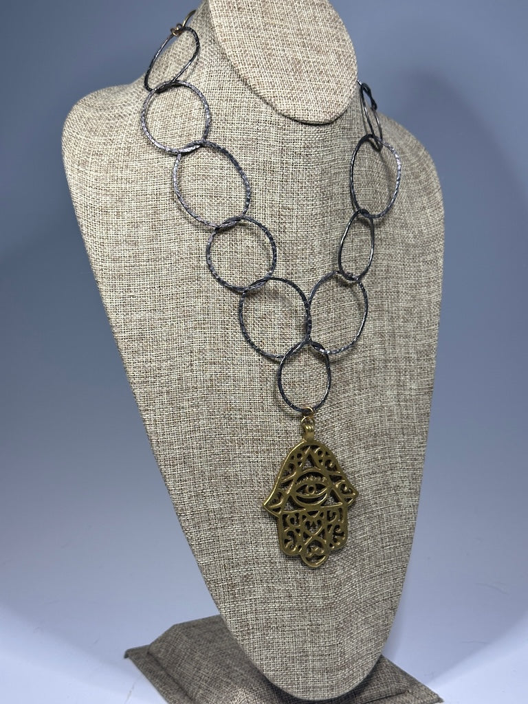 HEMATITE AND BRASS WABI SABI STATEMENT NECKLACE WITH LARGE BRASS HANSMA PENDANT LCN1087