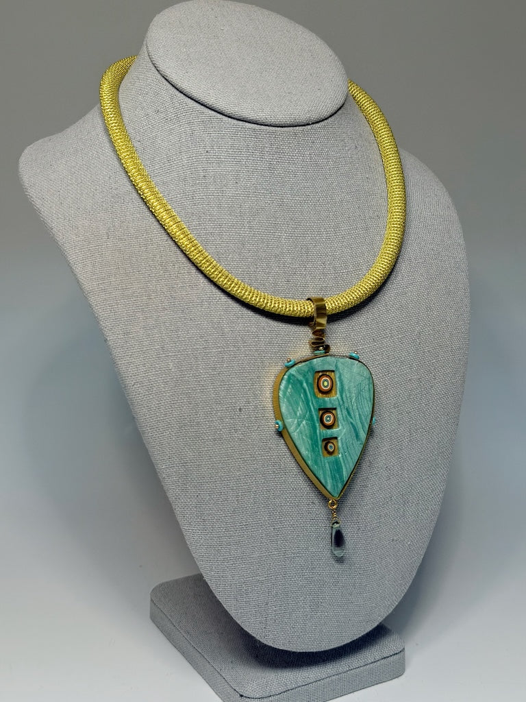 PETAL SHAPED PENDANT WITH CUT OUT WINDOWS WRAPPED IN BRASS METAL WITH GLASS DROP CHEQUE BEAD FRINGE AND TURQUOISE HESHI BEAD ACCENTS PCN900