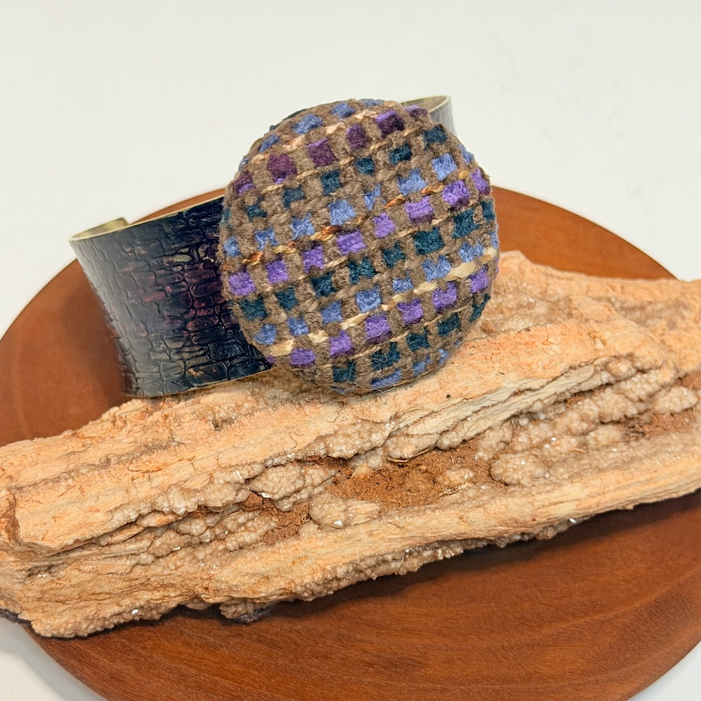 ANTICLASSIC BRASS CUFF WITH COBBLESTONE TEXTURE, BLUE-PURPLE PATINA & CABOCHON OF HANDWOVEN FABRIC JH167