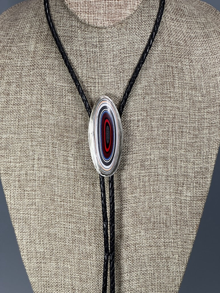 FORDITE CABOCHON BOLO IN STERLING SILVER BEZEL WITH AFRICAN GLASS BEADS, RED FACETED BEADS ON BLACK LEATHER CORD JH53