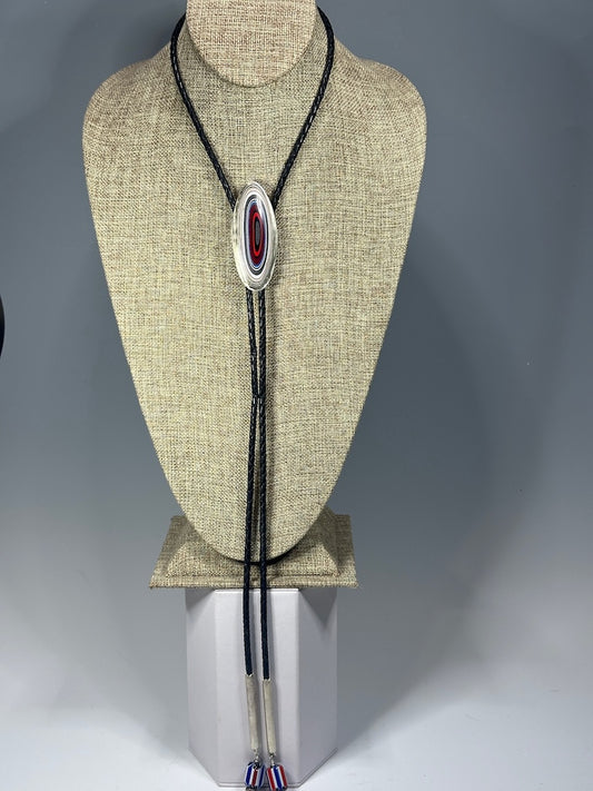 FORDITE CABOCHON BOLO IN STERLING SILVER BEZEL WITH AFRICAN GLASS BEADS, RED FACETED BEADS ON BLACK LEATHER CORD JH53