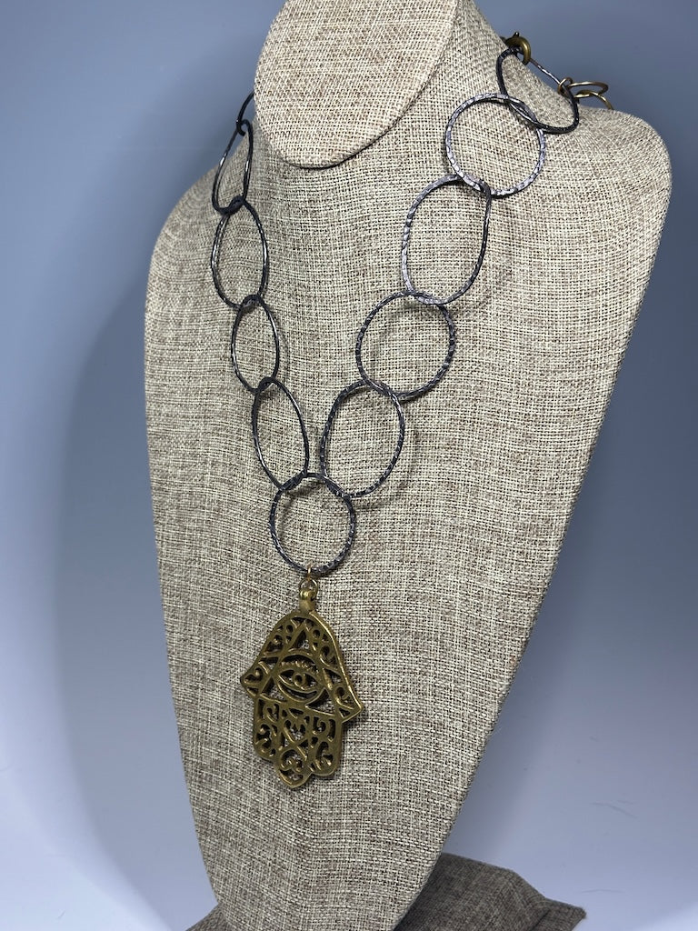 HEMATITE AND BRASS WABI SABI STATEMENT NECKLACE WITH LARGE BRASS HANSMA PENDANT LCN1087