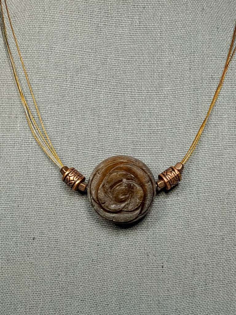 CARVED STONE FLORAL PENDANT ON STAINLESS AND COPPER NECK WIRE LCN3026