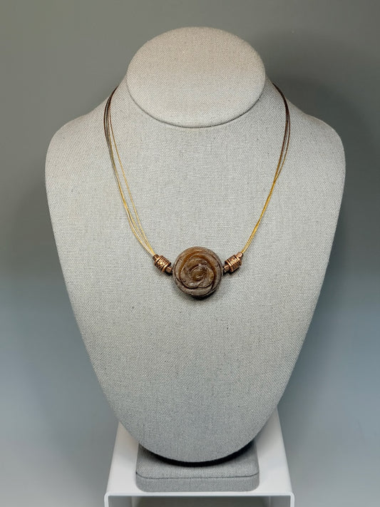CARVED STONE FLORAL PENDANT ON STAINLESS AND COPPER NECK WIRE LCN3026