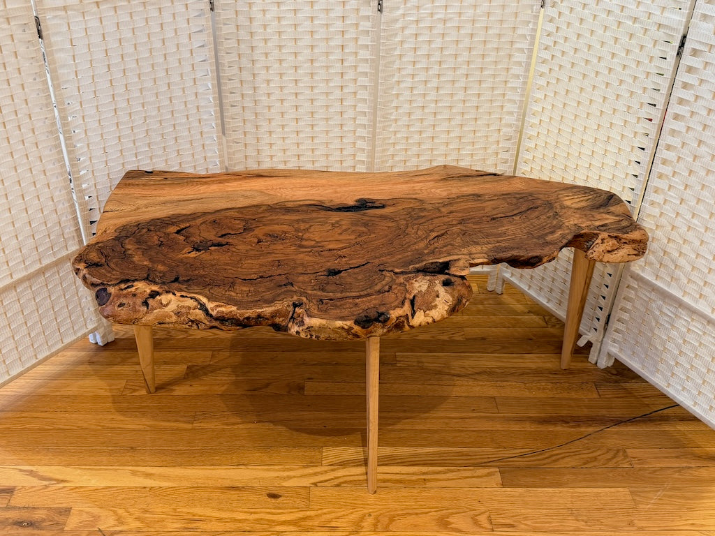 RED OAK BURL COFFEE TABLE WITH AMBROSIA MAPLE LEGS