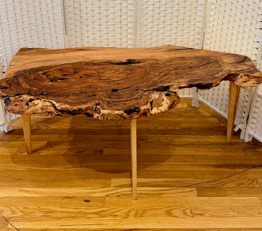RED OAK BURL COFFEE TABLE WITH AMBROSIA MAPLE LEGS