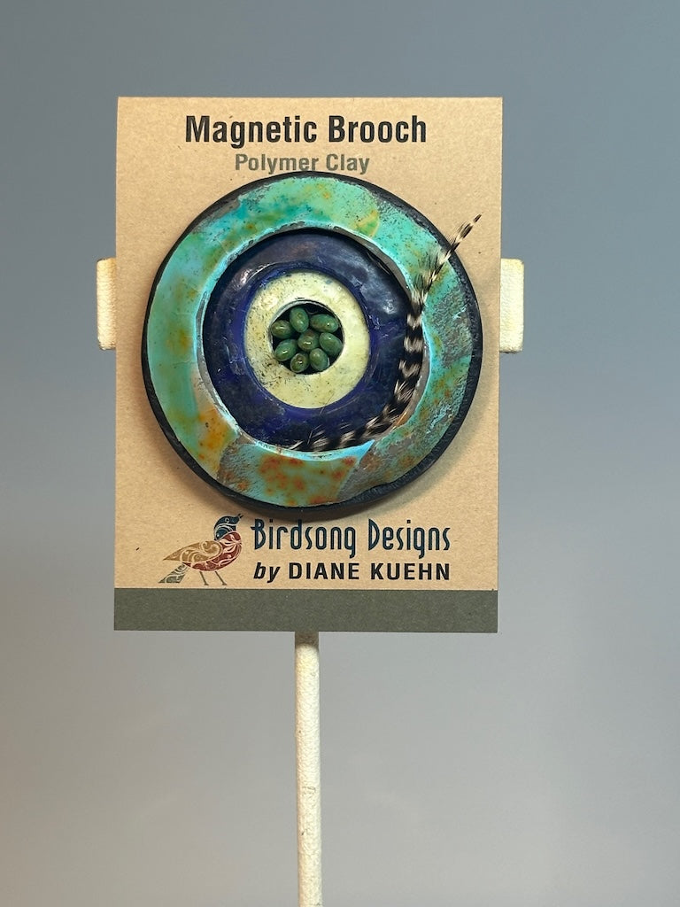 POLYMER CLAY MAGNETIC BROOCH WITH GLASS AND FEATHER ACCENTS PCB744