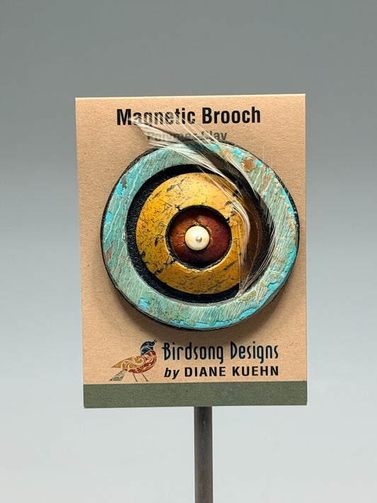 CONCENTRIC POLYMER CLAY MAGNETIC BROOCH WITH GLASS BEAD CENTER & FEATHER ACCENT PCB877