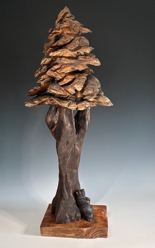 "SOLITUDE" WHITE PINE, GRAPHITE AND LEYLAND CYPRESS WOOD SCULPTURE